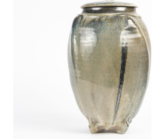 A large covered pot by Jean...